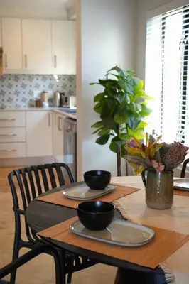 a kitchen with a table with two bowls on it at Modern Family Golf Lodge in Winelands Paradise in Paarl
