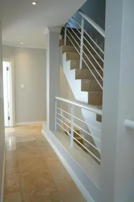 a staircase in a living room with a tile floor at Modern Family Golf Lodge in Winelands Paradise in Paarl