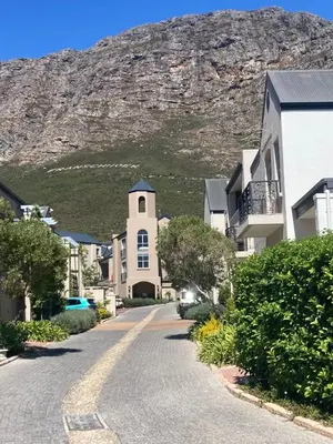 a street in a town with a mountain in the background at Villa 121 Franschhoek Lermitage in Franschhoek