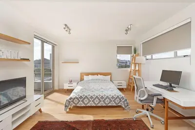 a bedroom with a bed and a desk and a computer at Dune Pavillion Beach Villa-Where the Ocean Meets the Mountain in Cape Town