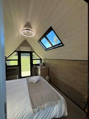 a bedroom with a bed in a tiny house at Leliefontein Eco Cottage and Glamping in Paarl