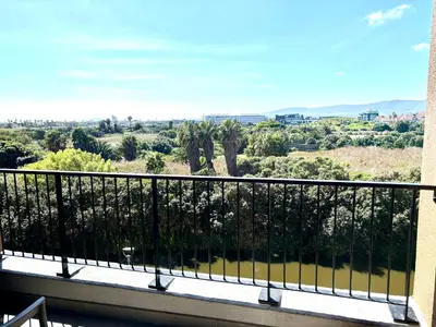 a balcony with a view of the countryside at Luxe watersedge apartment in Cape Town
