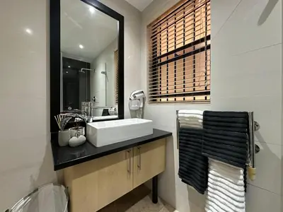 a bathroom with a sink and a mirror at 109 on Oudehoek in Stellenbosch