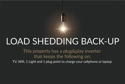 a load shedding back up poster with a light bulb at Dolphin Beach C110 Beachfront Beauty in Cape Town