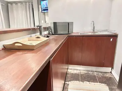 a kitchen with a wooden counter top with a sink and a microwave at Apartment in Bellville - self-catering in Bellville