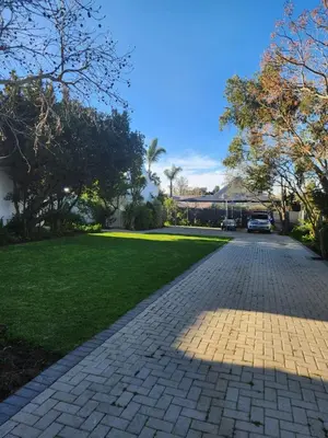 a cobblestone driveway in front of a house at Cape Dutch haven in Durbanville