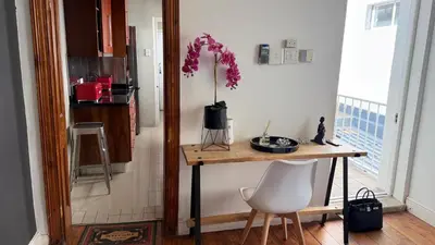a kitchen with a table and a vase of flowers at Obs Centre The Lookout in Cape Town