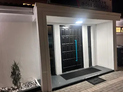 a front door of a house with a blue light at Jorash Guesthouse in Cape Town