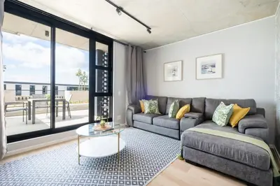 a living room with a couch and a table at 318 Riverlands - Lux 1 bedroom Apartment in Cape Town