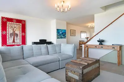 a living room with a couch and a fireplace at Dolphin Beach C111 Sea -Table Mountain Views at Dolphin Beach in Cape Town