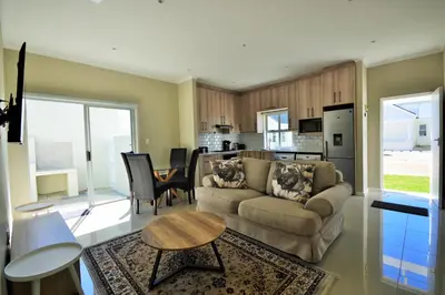 a living room with a couch and a table at Tweespruit Estate - Stellenbosch- 3 Bedroom House in Stellenbosch