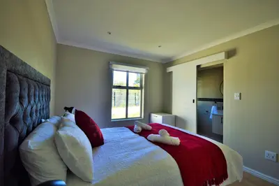 a bedroom with a bed with two stuffed animals on it at Tweespruit Estate - Stellenbosch- 3 Bedroom House in Stellenbosch