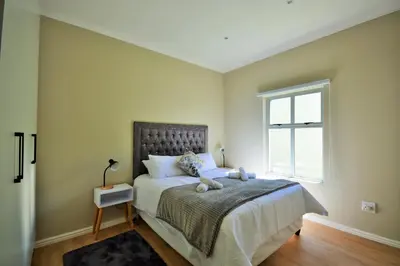 a bedroom with a bed with a teddy bear on it at Tweespruit Estate - Stellenbosch- 3 Bedroom House in Stellenbosch