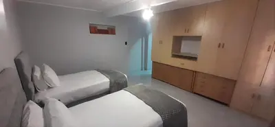a hotel room with two beds and a tv at RoomIsGood in Cape Town