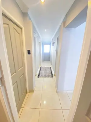 a hallway with a tile floor and a door at Modern Stylish Home In Cape Town in Cape Town
