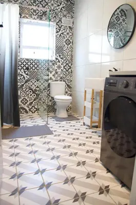 a bathroom with a washer and dryer on the floor at Modern Stylish Home In Cape Town in Cape Town