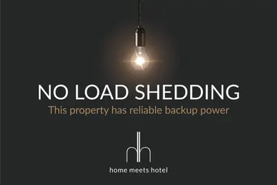 a sign that says no load shedding with a light at Dolphin Beach H205 Beachfront APT, Blouberg by HMH in Cape Town