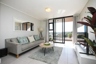 a living room with a couch and a table at Family Suite-Two Bedroom Waters Edge in Cape Town
