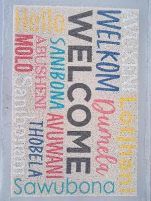 a sign with different colored words on a wall at Deo Volente Self-Catering Cottage in Kuilsrivier
