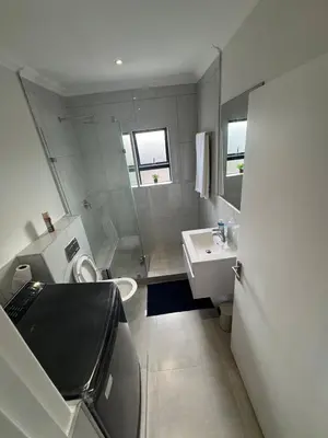 a small bathroom with a toilet and a sink at DRJ Luxe Table view in Table View