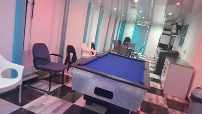 a room with a pool table and two chairs at Goodwood Neo & Ruks guest house in Goodwood