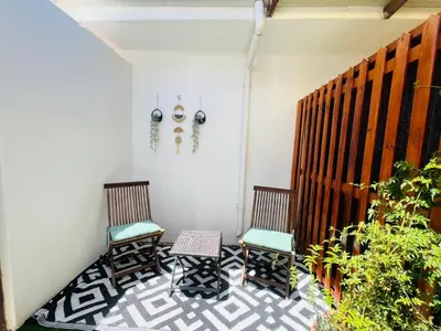 two chairs and a table on a patio at Bahlaloga Studio Durbanville in Durbanville