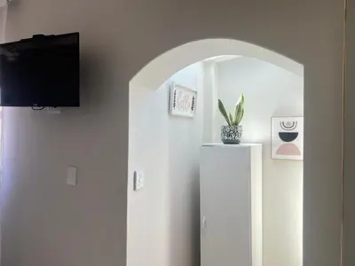a room with an arched doorway with a potted plant at Bahlaloga Studio Durbanville in Durbanville