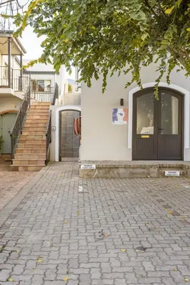 a building with a door and a brick sidewalk at Tram View Hideaway in Franschhoek