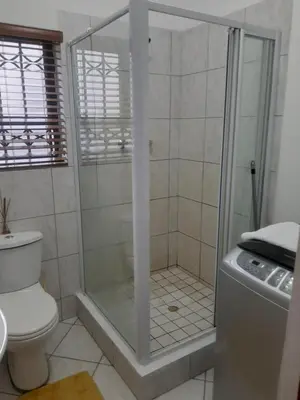 a shower with a glass door in a bathroom at Local & Comfortable in Mandalay