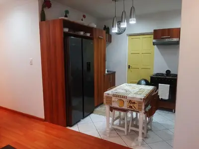 a kitchen with a table and a kitchen with yellow doors at Local & Comfortable in Mandalay
