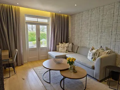 a living room with a couch and a table at Winelands Golf Lodges 34 at De Zalze in Cape Town