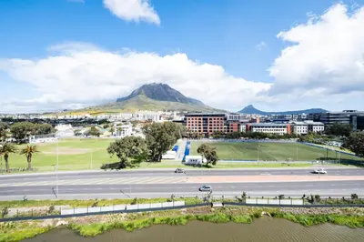 a view of a city with a mountain in the background at Riverlands - Mountain View 1-BR Premium Apartment in Cape Town