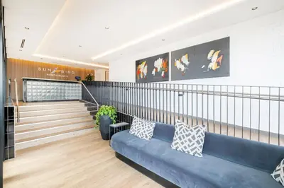 a lobby with a blue couch in a building at Riverlands - Mountain View 1-BR Premium Apartment in Cape Town