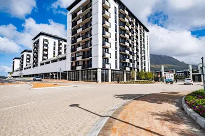 an empty street in front of a large building at Riverlands - Mountain View 1-BR Premium Apartment in Cape Town