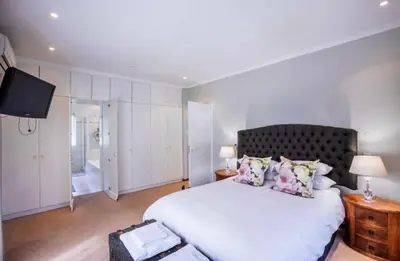a bedroom with a large bed and a television at Akasia 1 in Caledon