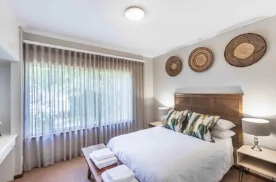 a bedroom with a large bed and a window at Akasia 1 in Caledon
