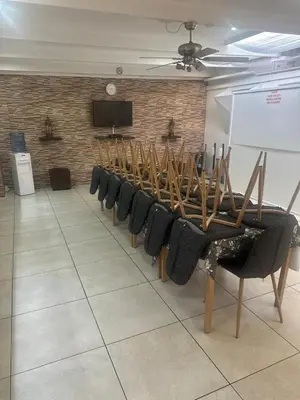 a room with a row of chairs and a white board at Surrey B&B in Surrey Estate
