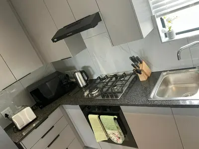a small kitchen with a stove and a sink at DRJ Luxe in Cape Town