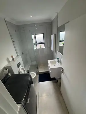 a small bathroom with a toilet and a sink at DRJ Luxe in Cape Town