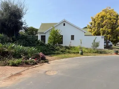 a white house with a road in front of it at Rose Garden, a Self-catering cottage in Worcester