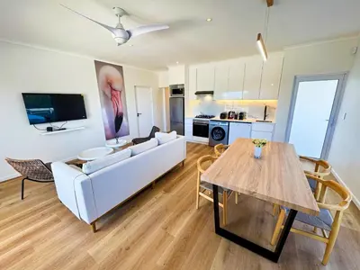 a living room with a couch and a table at Peach On Beach Boutique Apartments in Hermanus