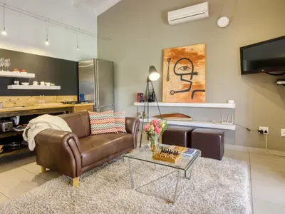 a living room with a couch and a table at The Residence Boutique Hotel in Grabouw