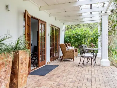a patio with chairs and a table on a patio at The Residence Boutique Hotel in Grabouw