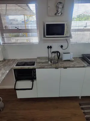 a kitchen with a stove and a counter top at Birds Holiday Accommodation 1 in Zeekoevlei