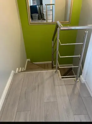 a stairwell with a green wall and a mirror at Western Cape in Cape Town