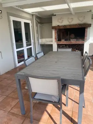 a table and chairs on a patio with a fireplace at Western Cape in Cape Town