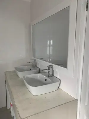 a bathroom with two sinks and a large mirror at Western Cape in Cape Town