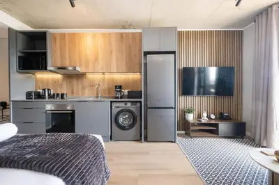 a kitchen with a washer and dryer in a room at 507 Riverlands - Lux Studio Apartment in Cape Town