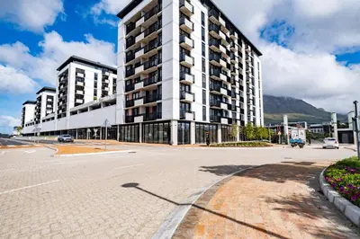 an empty street in front of a large building at 507 Riverlands - Lux Studio Apartment in Cape Town