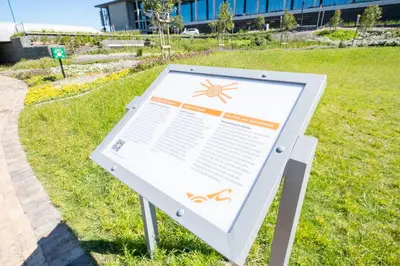 a sign in the grass next to a field at 705 Riverlands - 1Bedroom Apartment with Mountain Views in Cape Town